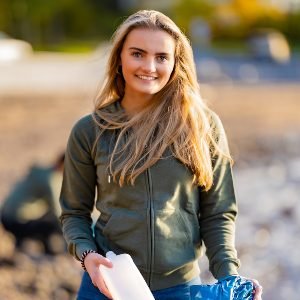 smiling-female-volunteer-holding-bottle-and-garbag-2021-08-28-13-43-36-utc.jpg